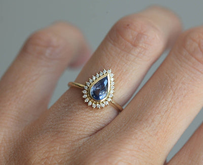 Birnenförmiger blauer Saphirring mit Diamant-Heiligenschein