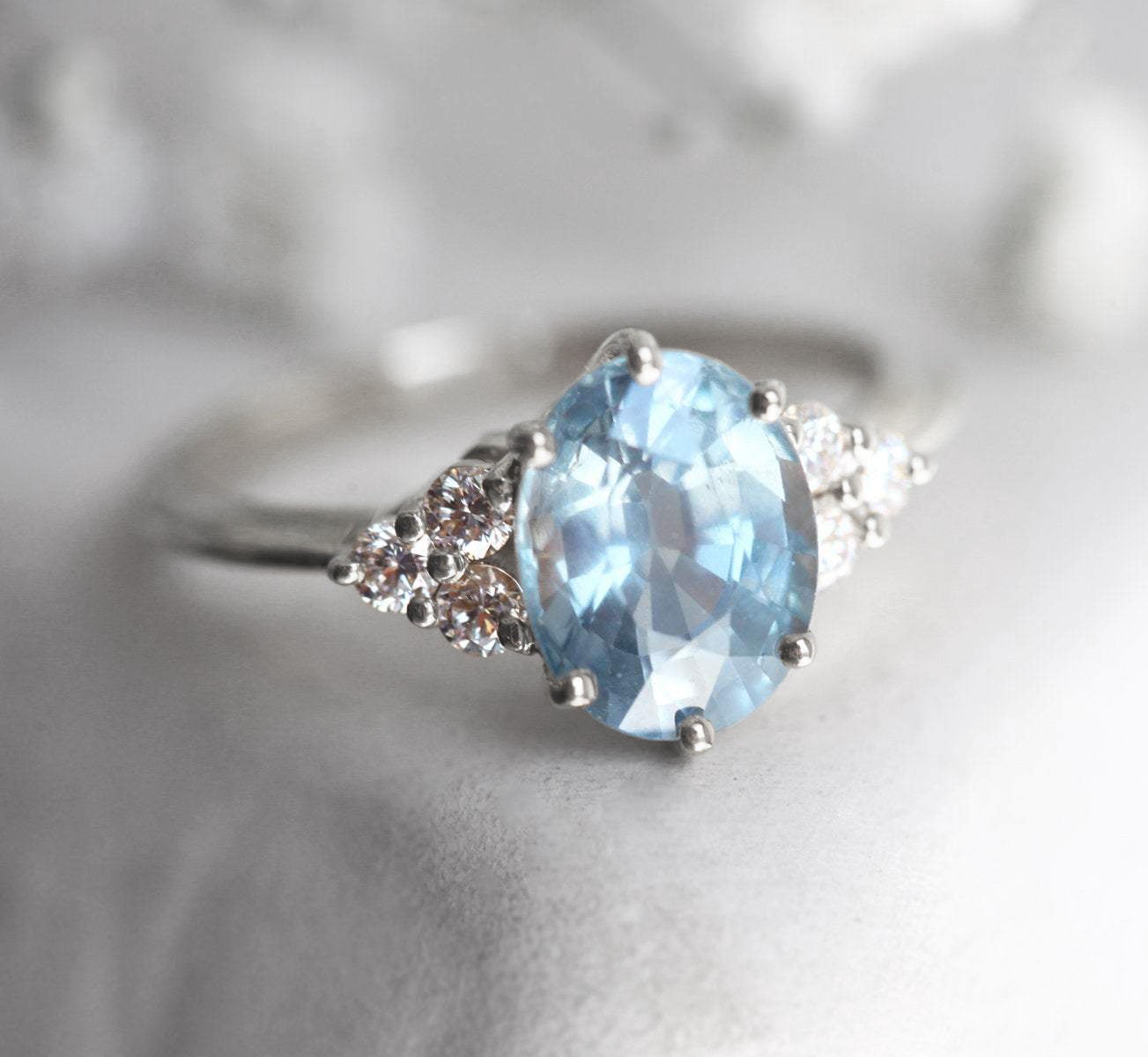 Ovaler blauer Saphirring mit Diamantcluster