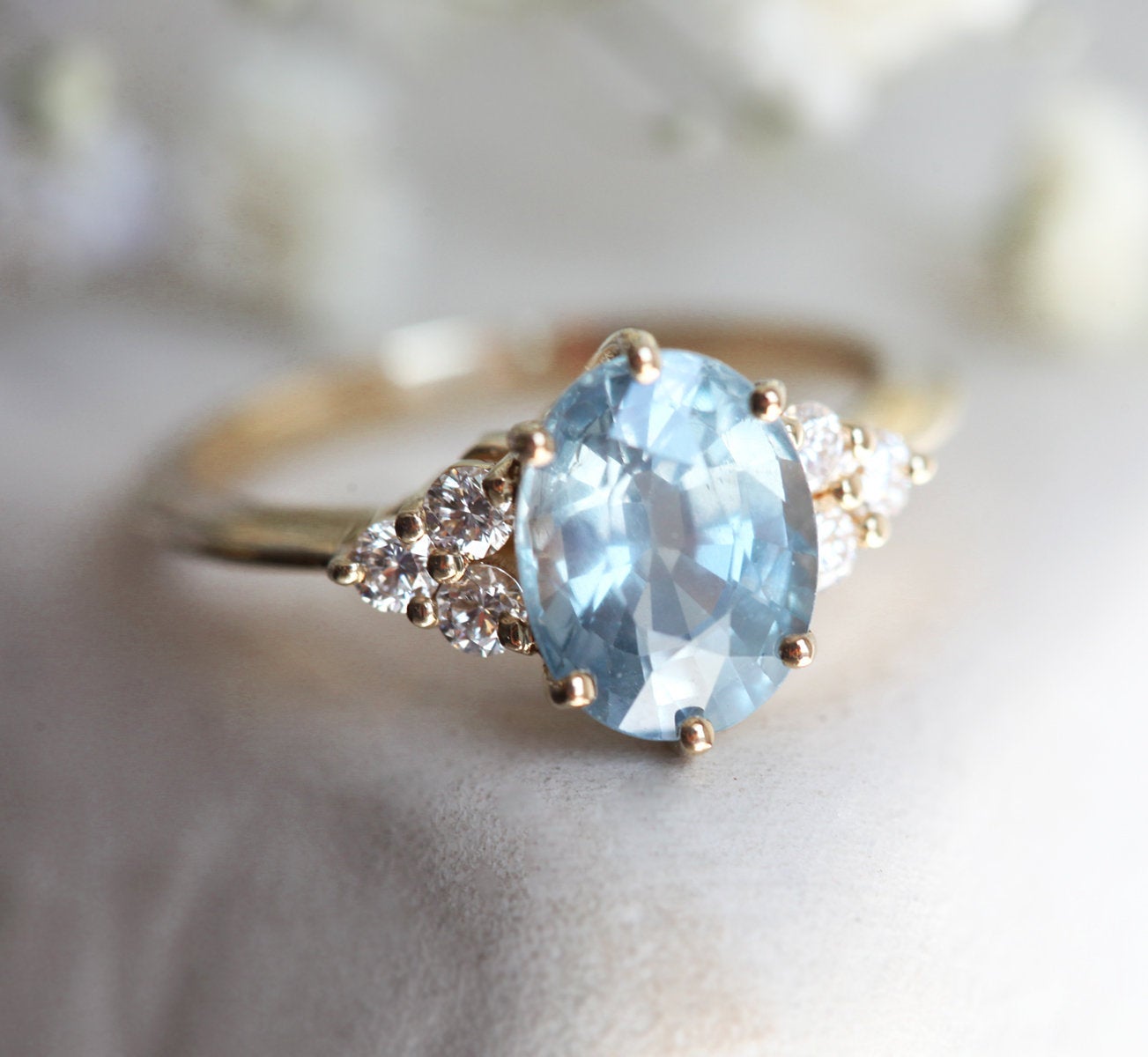 Ovaler blauer Saphirring mit Diamantcluster