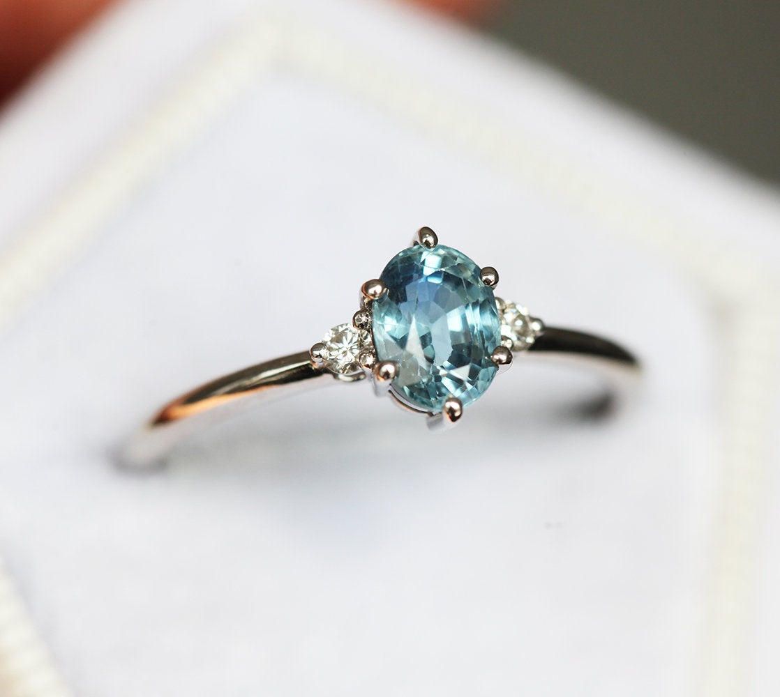 Ovaler blauer Saphirring mit seitlichen Diamanten