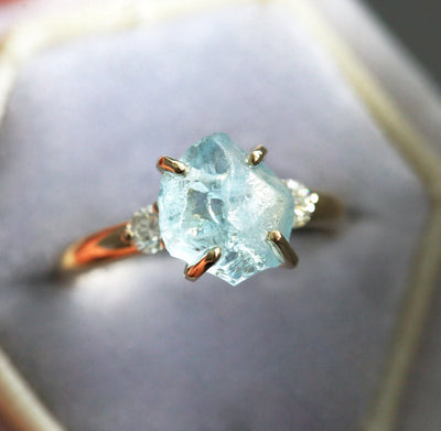 Ring aus drei Steinen im Rohschliff mit Aquamarin und zwei runden weißen Diamanten